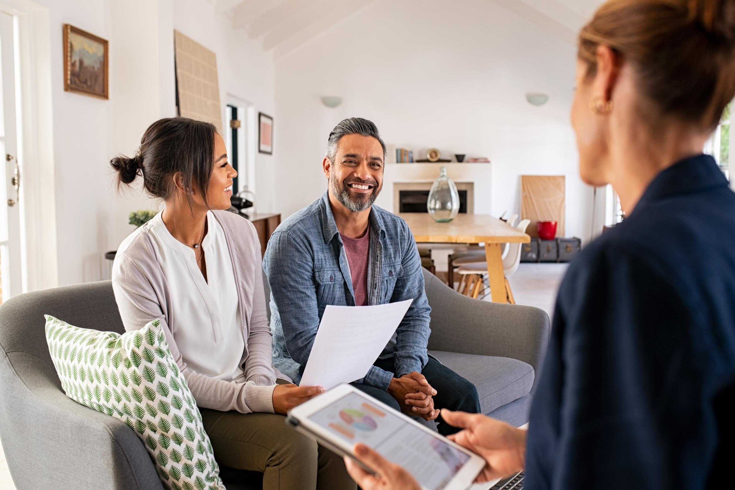Homeowners reviewing paperwork with an advisor